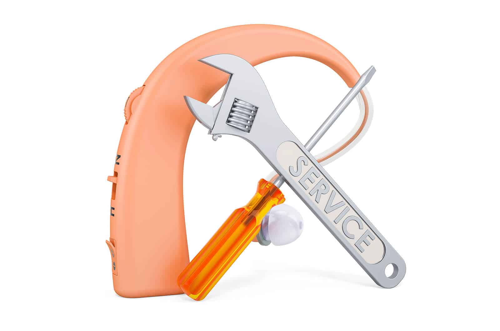 Hearing aid repair tools over orange hearing aid
